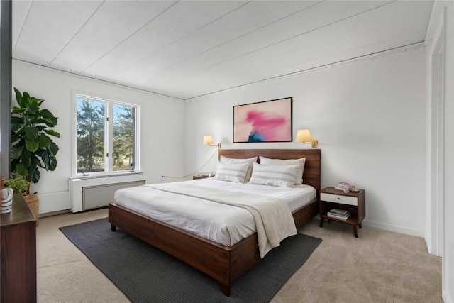 bedroom featuring baseboards and light colored carpet