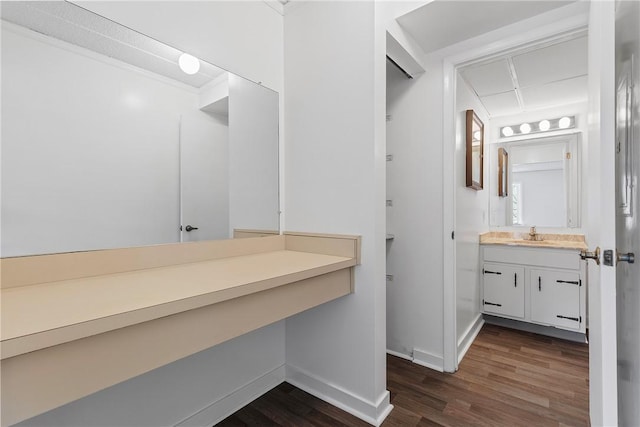 bathroom featuring wood finished floors, vanity, and baseboards