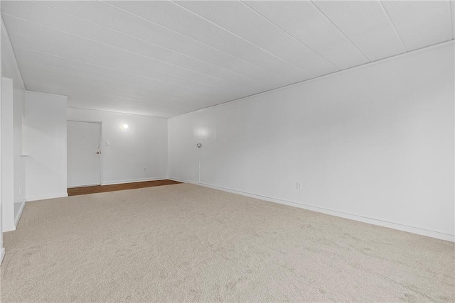 carpeted spare room with baseboards