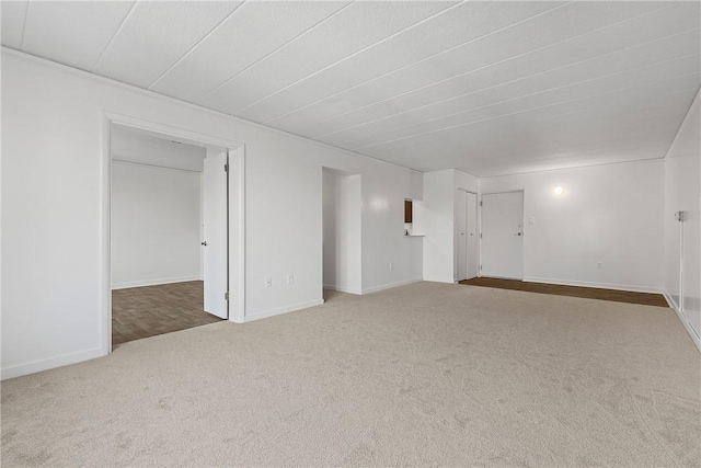 carpeted spare room with baseboards