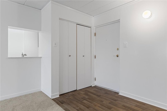 interior space with dark wood-style floors, baseboards, and a closet