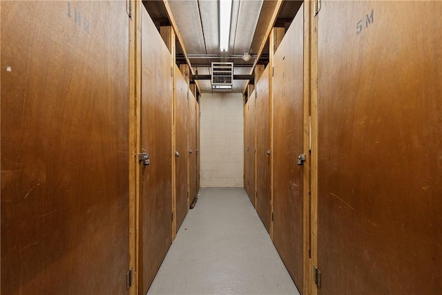 hall featuring concrete floors and visible vents