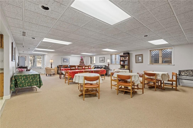 interior space featuring a drop ceiling, visible vents, and baseboards