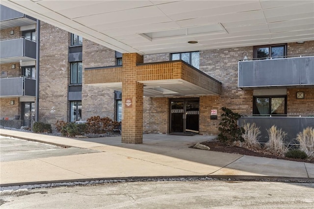 entrance to property featuring brick siding