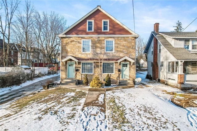 view of front of property with entry steps and stone siding