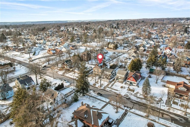 snowy aerial view with a residential view