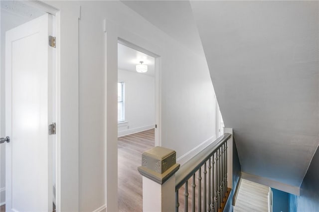 hall featuring light wood finished floors and baseboards