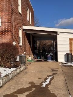 view of home's exterior featuring driveway and central AC unit