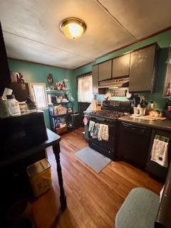 kitchen featuring black appliances, light wood-style flooring, and under cabinet range hood