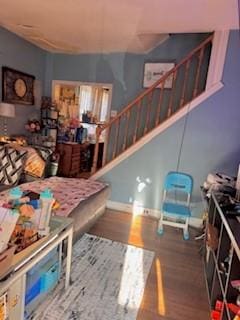 dining space featuring stairs and wood finished floors