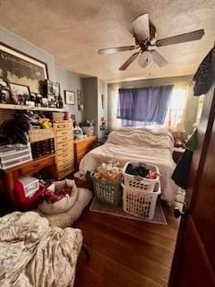 bedroom with ceiling fan, a textured ceiling, and wood finished floors