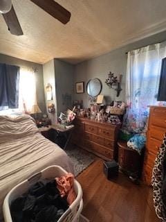 bedroom with a ceiling fan and wood finished floors