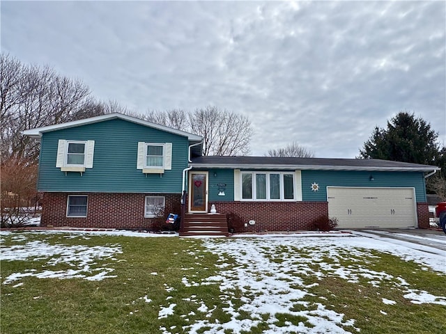 split level home with driveway, brick siding, and an attached garage