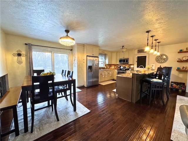 dining area featuring dark wood finished floors and a textured ceiling