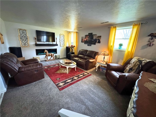 carpeted living room with a textured ceiling, a fireplace, and visible vents