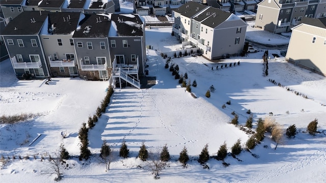 snowy aerial view with a residential view