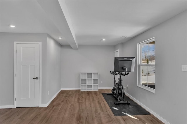 workout room with baseboards, wood finished floors, and recessed lighting