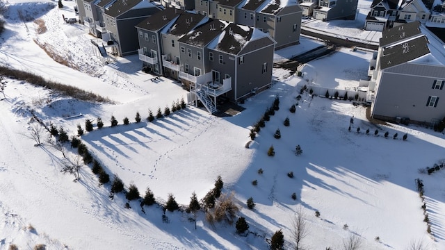 snowy aerial view with a residential view