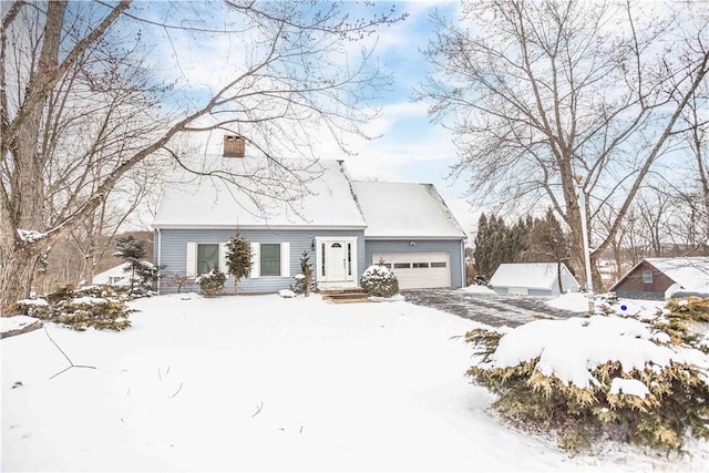 view of front of home with a garage and a chimney