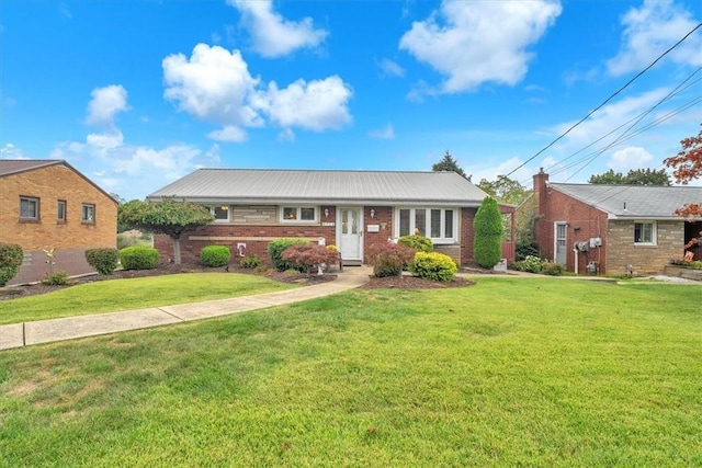 single story home with a front yard and brick siding