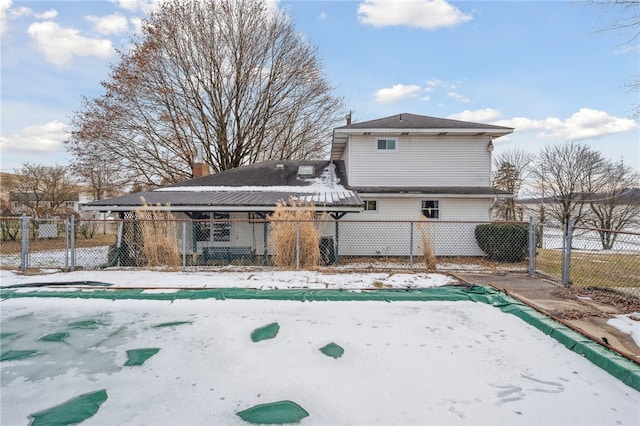 rear view of property with fence