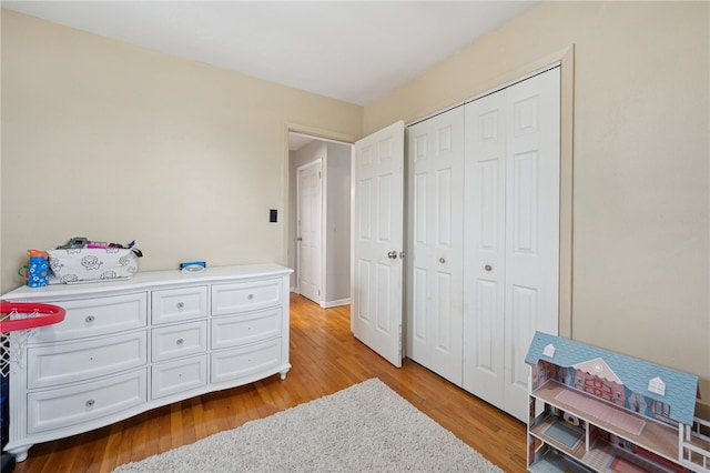 bedroom featuring light wood-style floors and a closet