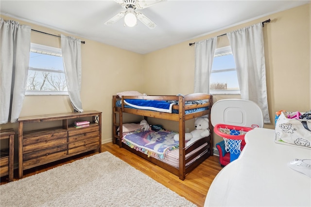 bedroom featuring a ceiling fan and wood finished floors