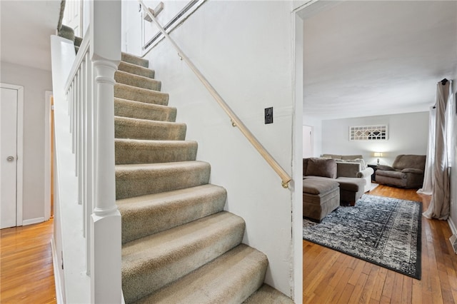 stairs featuring wood finished floors