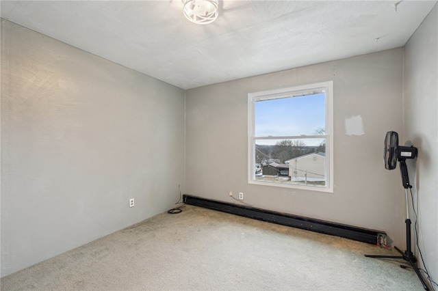 carpeted empty room with a baseboard radiator