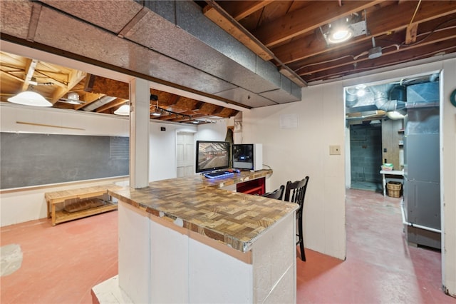 kitchen featuring concrete floors and heating unit