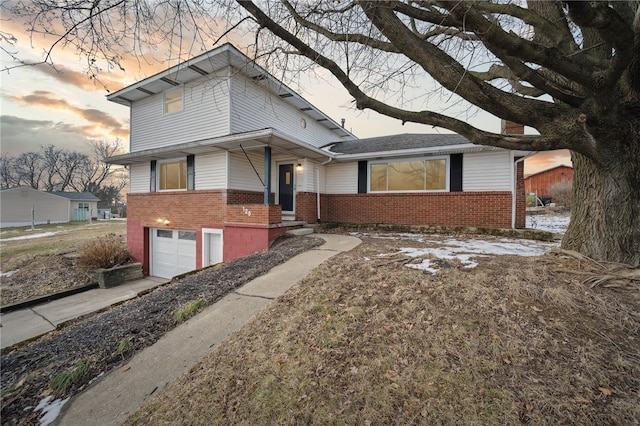 view of side of home featuring brick siding and an attached garage