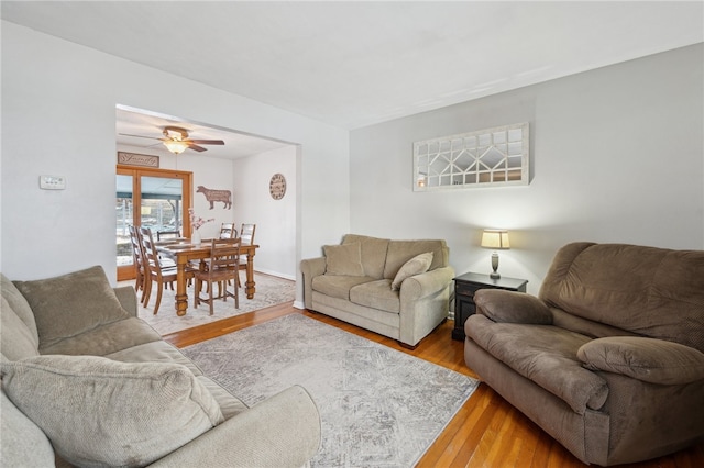 living area with ceiling fan and wood finished floors