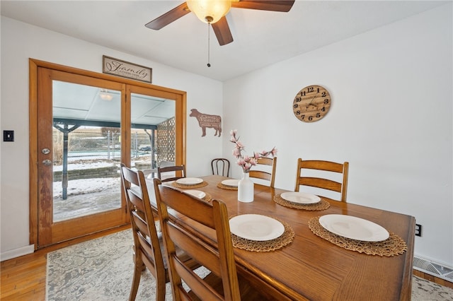 dining room featuring a ceiling fan, light wood-type flooring, and visible vents