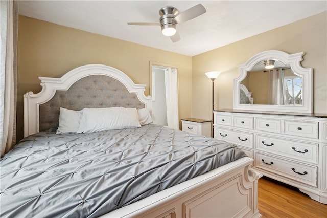 bedroom featuring light wood-style flooring and a ceiling fan