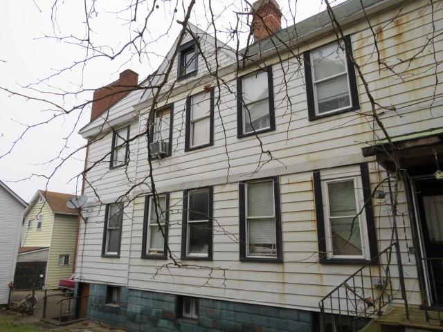 view of property exterior featuring a chimney