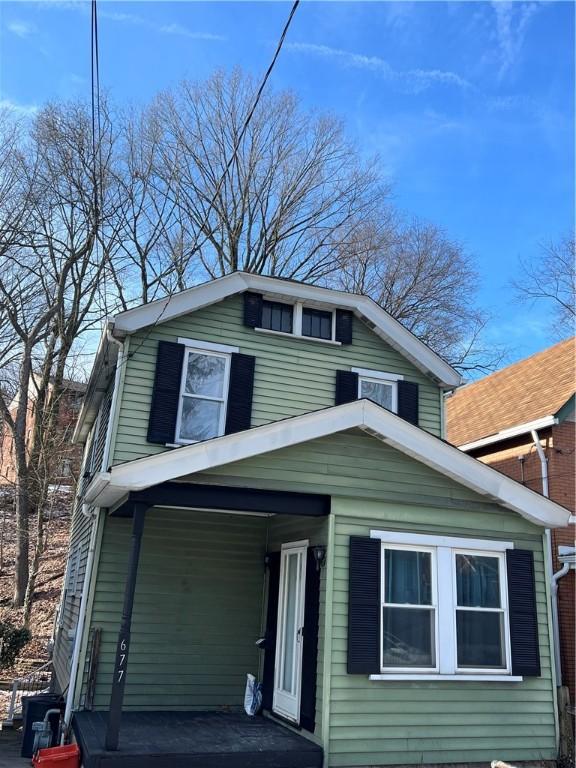 view of front of property featuring a porch and an attached carport