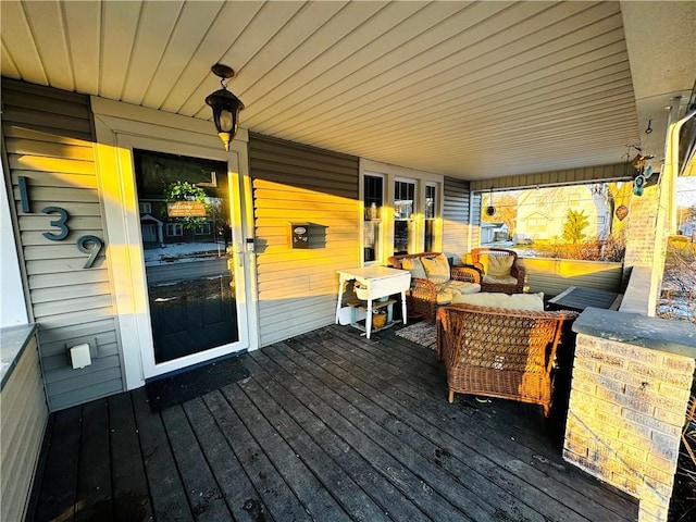 wooden terrace featuring an outdoor living space