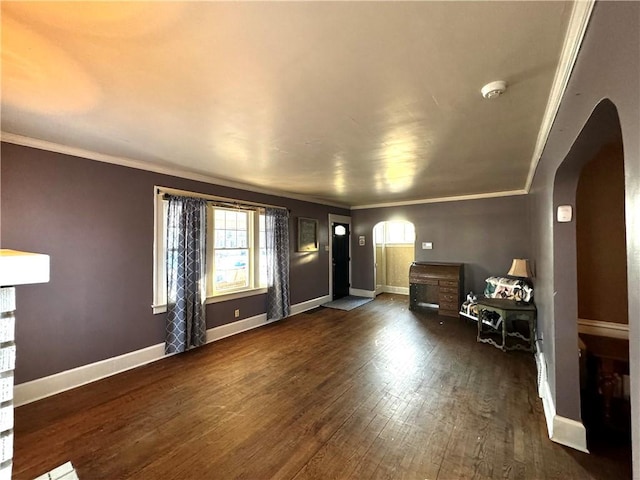 entrance foyer featuring baseboards, crown molding, arched walkways, and dark wood-style flooring