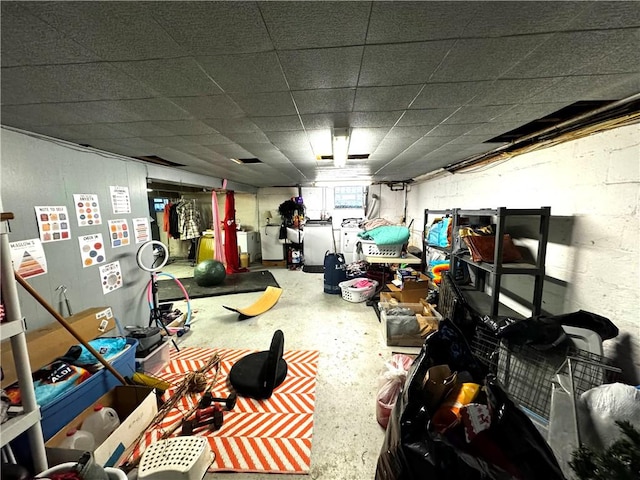 interior space featuring separate washer and dryer and a paneled ceiling