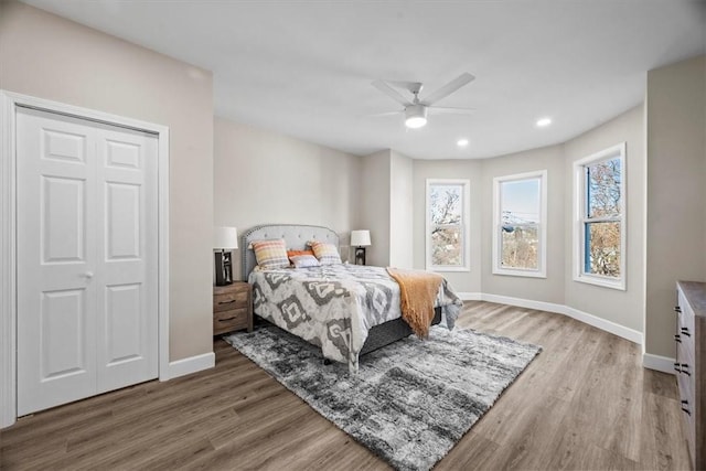 bedroom with a ceiling fan, recessed lighting, baseboards, and wood finished floors