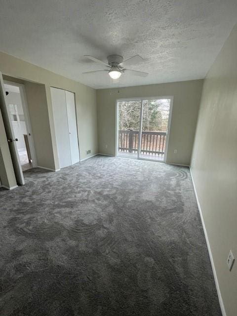 unfurnished bedroom featuring a textured ceiling, access to outside, carpet flooring, and baseboards