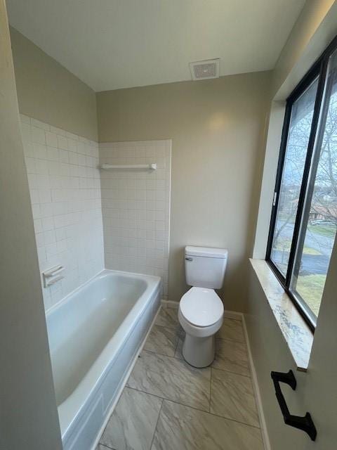 full bathroom featuring toilet, marble finish floor, visible vents, and baseboards