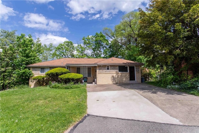 single story home featuring brick siding, driveway, and a front lawn