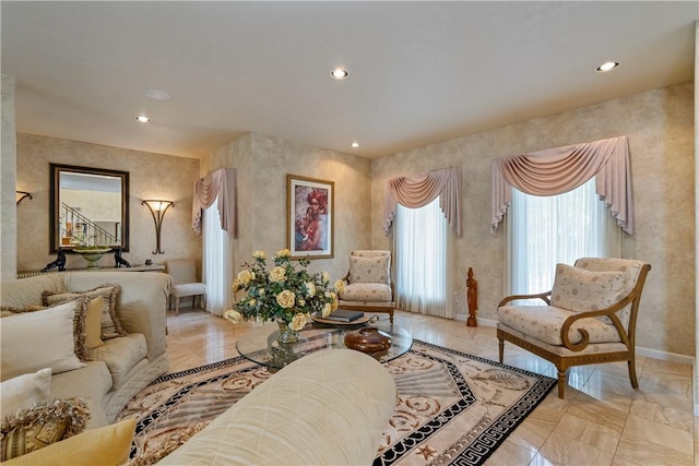 living area featuring recessed lighting and baseboards