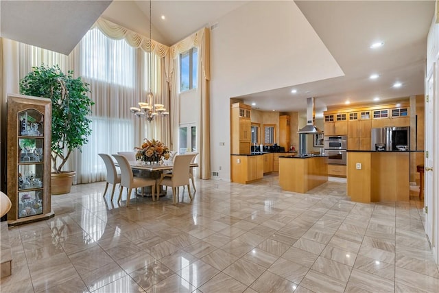 kitchen featuring a center island, dark countertops, glass insert cabinets, appliances with stainless steel finishes, and ventilation hood