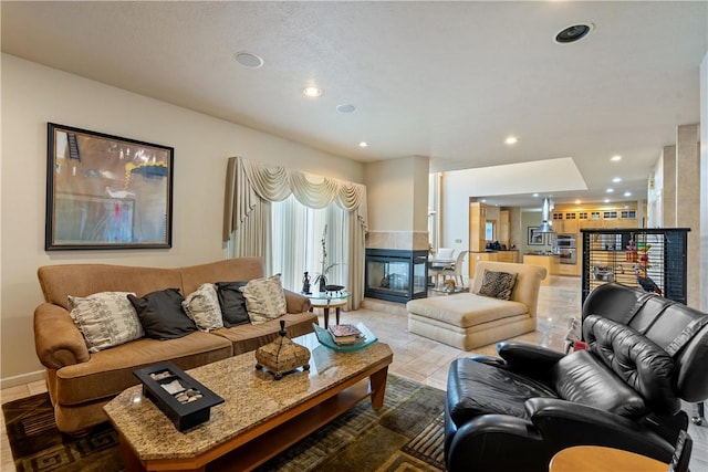 living room featuring recessed lighting, a fireplace, and light tile patterned floors