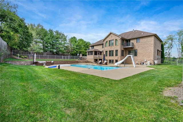 view of pool with a fenced in pool, a yard, a patio, a water slide, and a fenced backyard