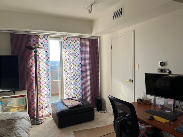 home office featuring light colored carpet, visible vents, and track lighting