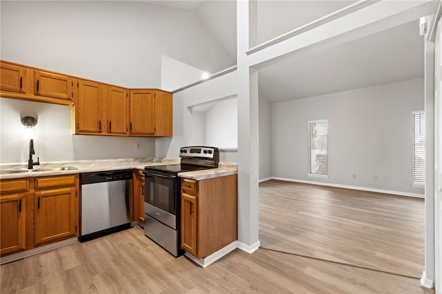 kitchen with a healthy amount of sunlight, appliances with stainless steel finishes, light countertops, and a sink