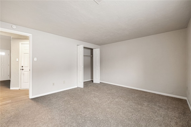 unfurnished bedroom with a closet, carpet, and baseboards